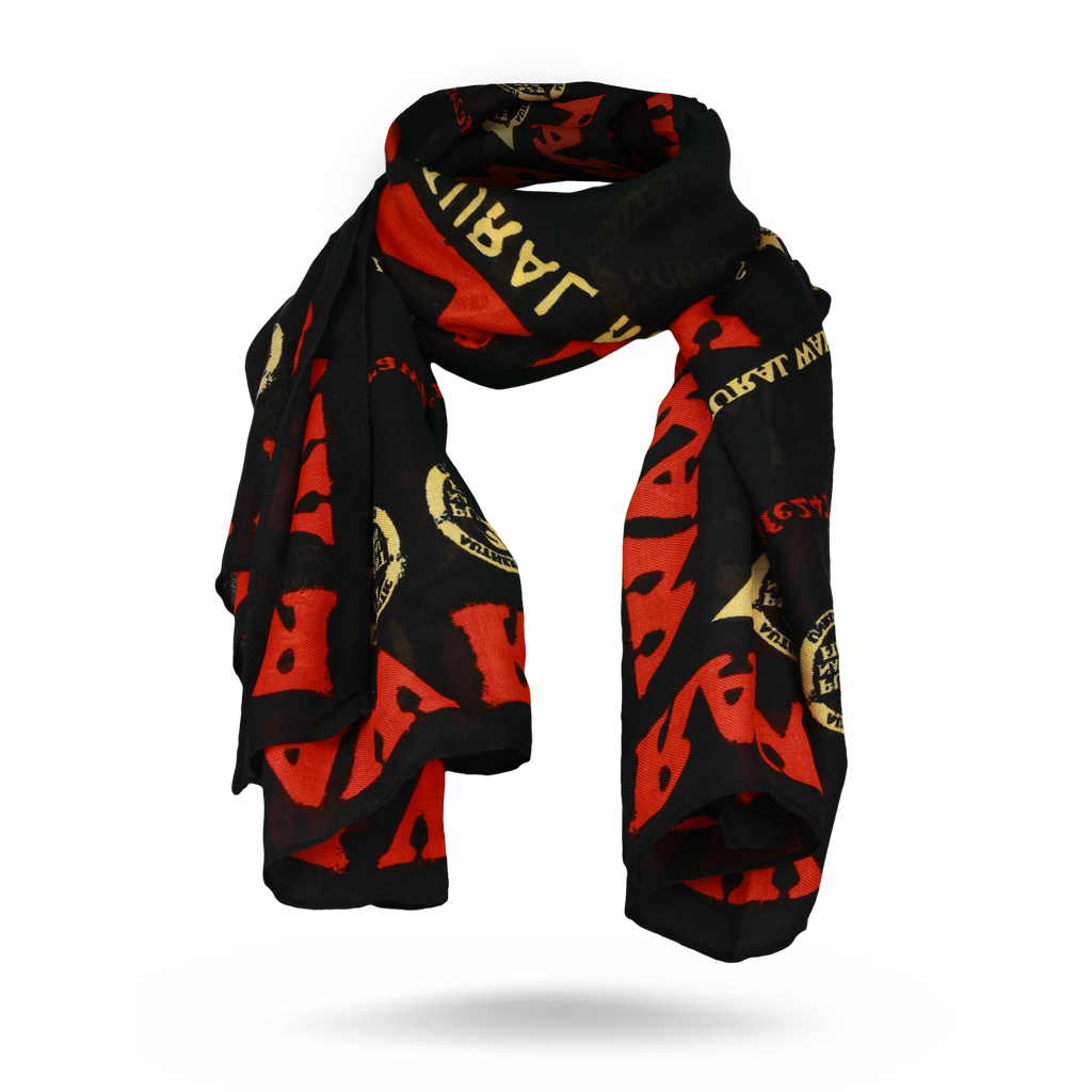 Black RAW fashion scarf with red and gold print, draped to show its fabric and shape
